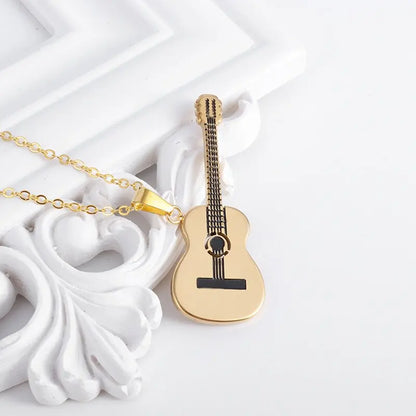 Acoustic Guitar Necklace Gold near frame | Sacred Tune