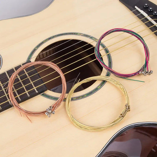 Acoustic guitar strings in bundles sitting atop an acoustic guitar. | Sacred Tune